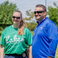 Two players smile together wearing GV gear and sunglasses
